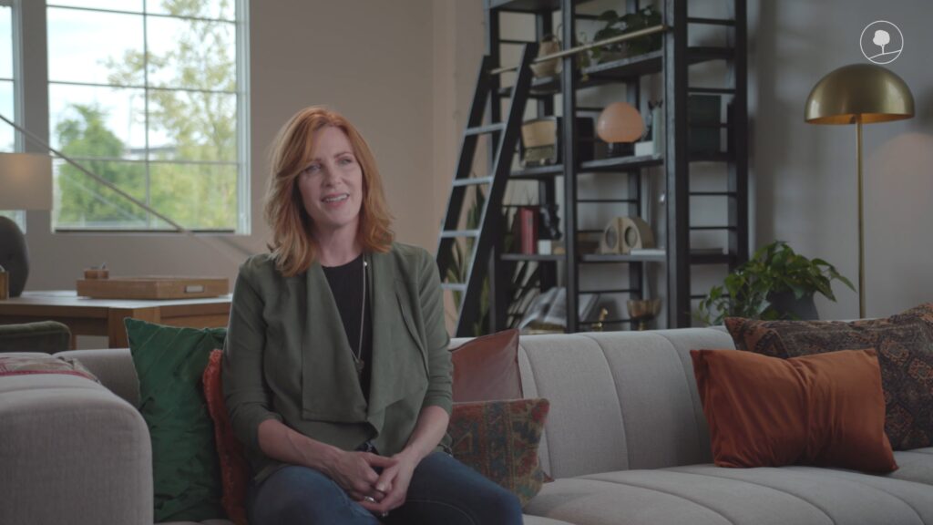 Jennifer, milestones's alum, sitting on couch